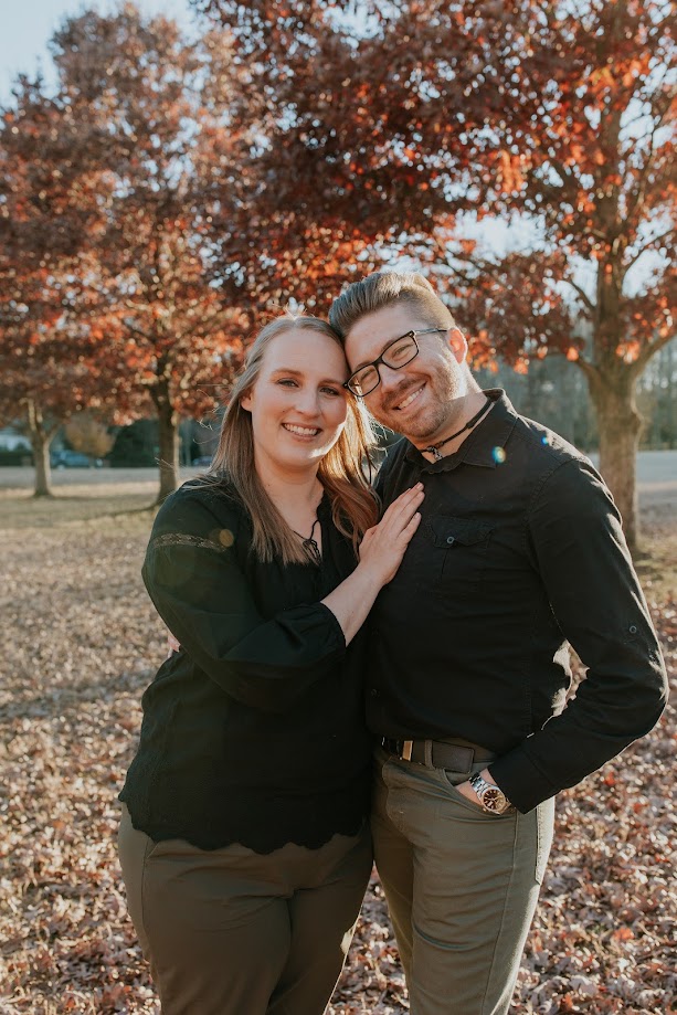 Anna and John standing in the park.